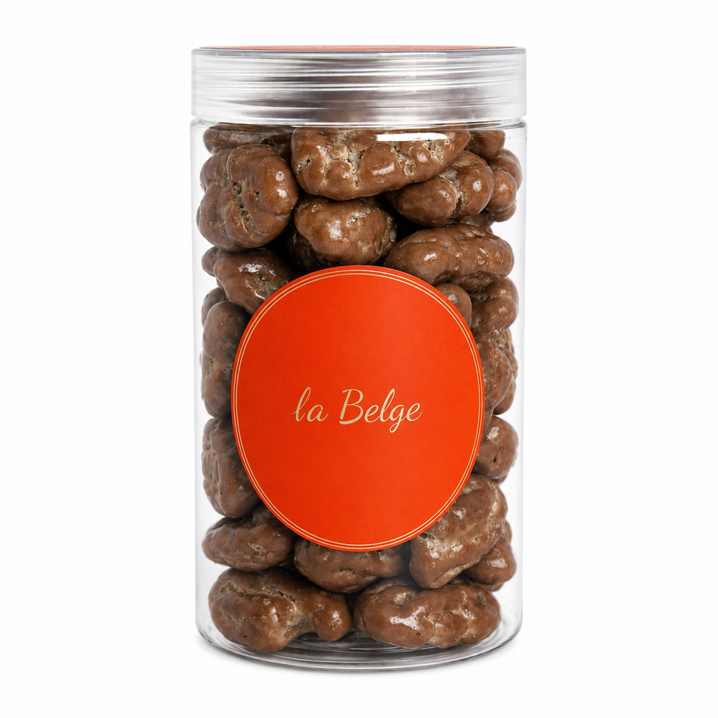 Premium Belgian milk chocolate coated pecans in a clear La Belge cylinder.