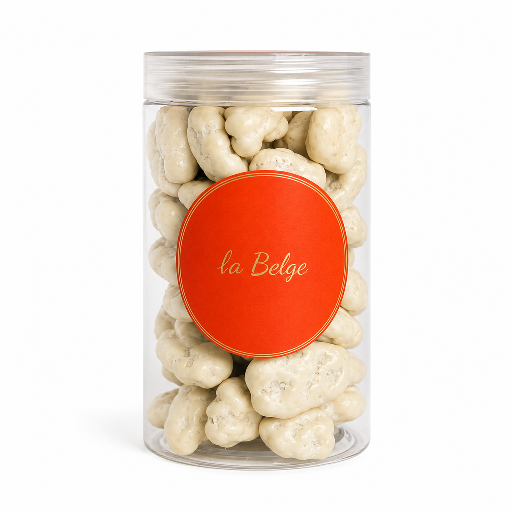 Premium Belgian white chocolate coated pecans in a clear La Belge jar.
