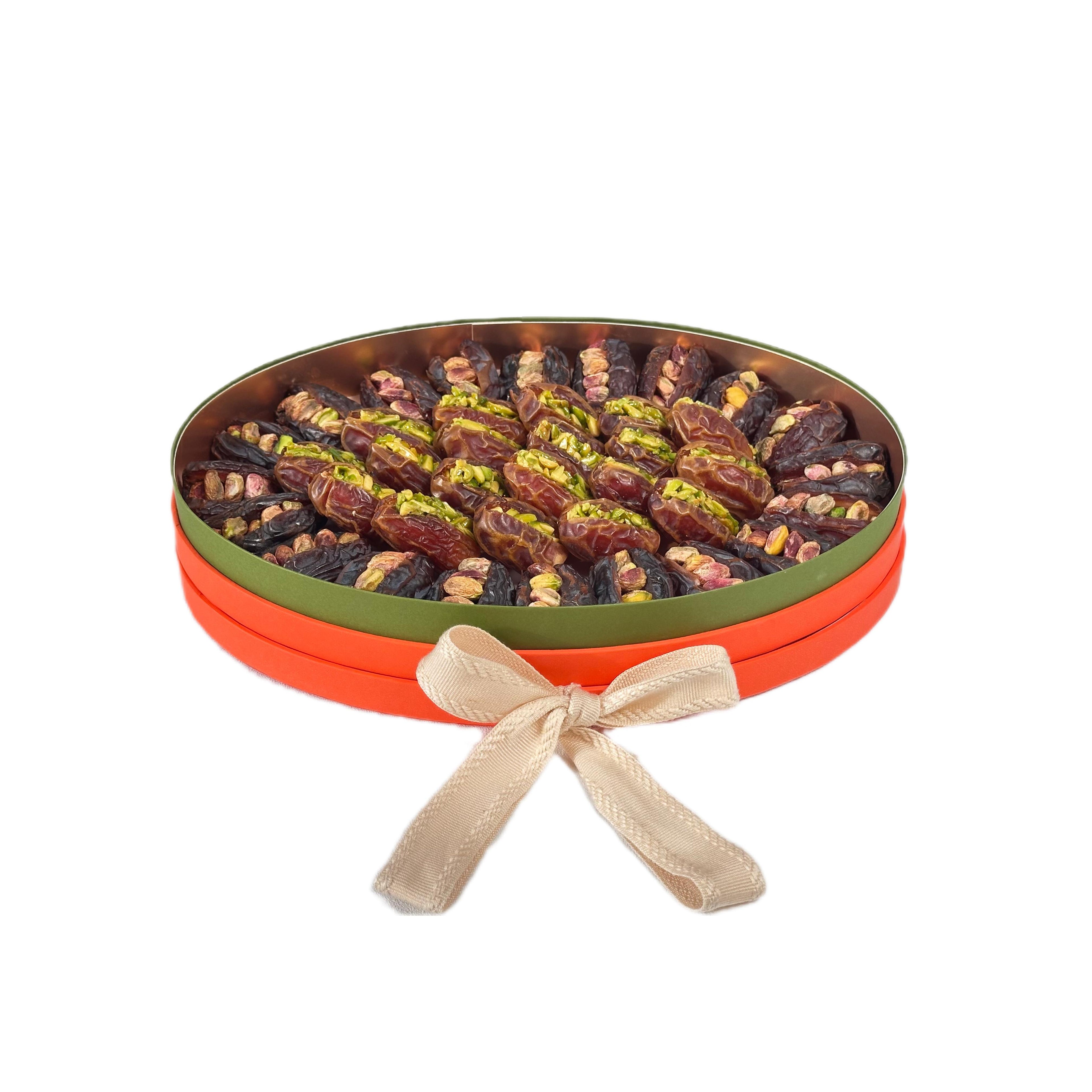 Open box of Medjool and Sagai dates stuffed with pistachio by La Belge