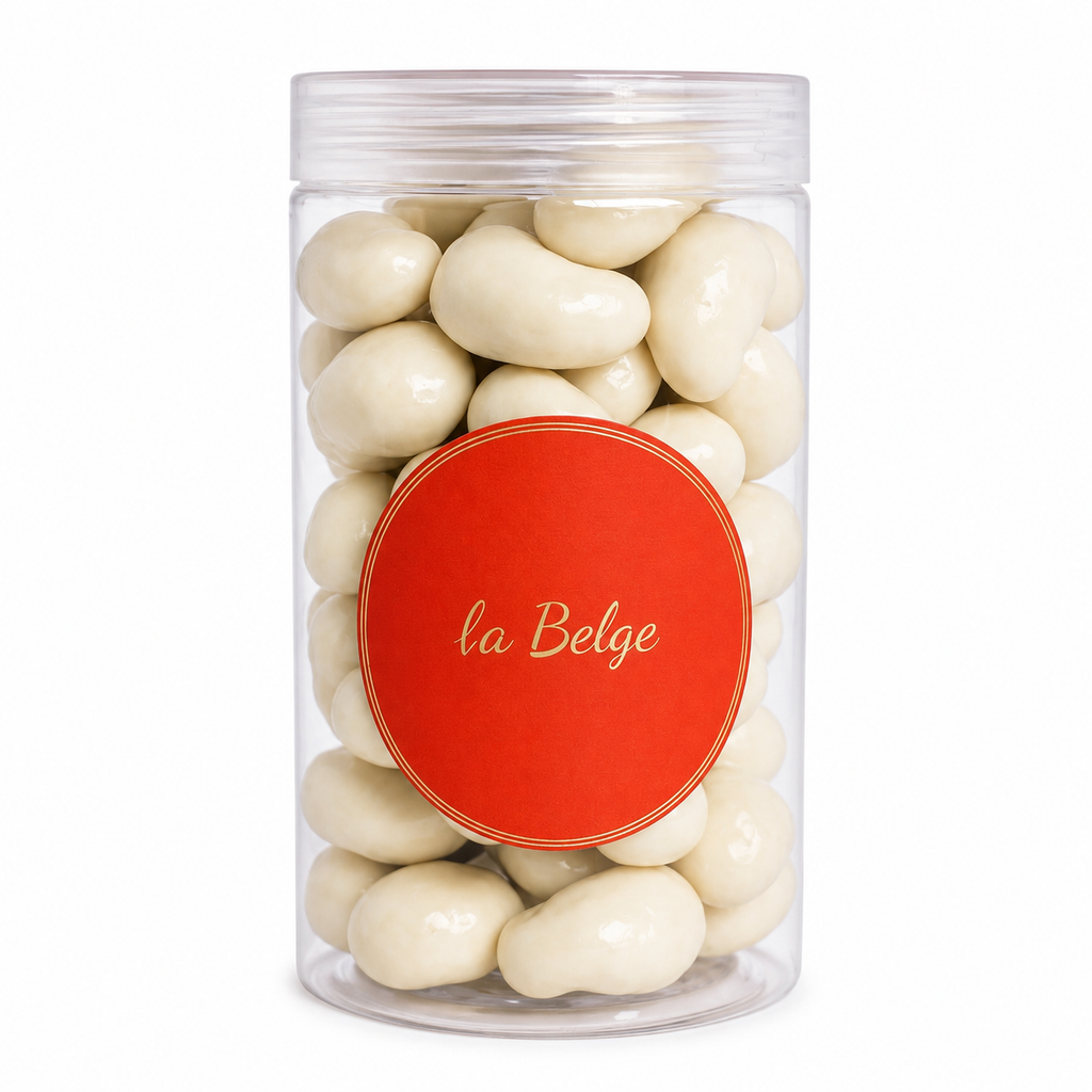 Clear jar filled with cashews coated in smooth Belgian milk chocolate by La Belge.